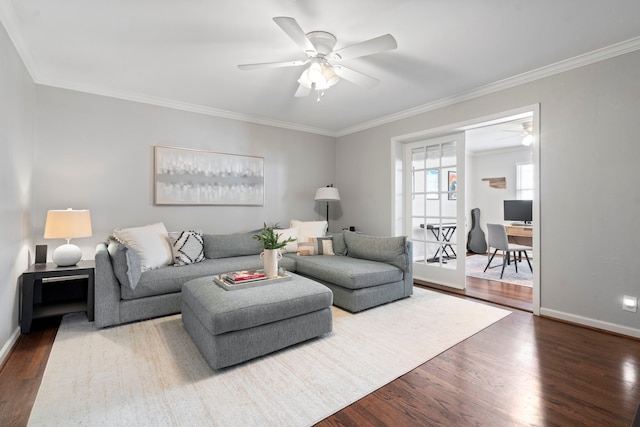 living area featuring ceiling fan, wood finished floors, and ornamental molding