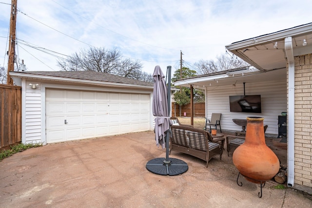 detached garage featuring fence