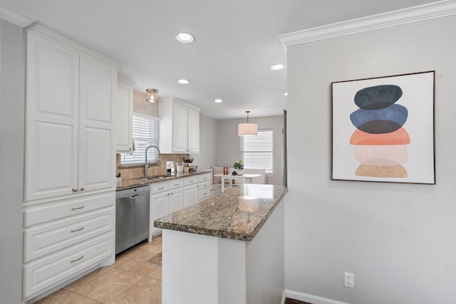 kitchen featuring a sink, stainless steel dishwasher, white cabinetry, dark stone counters, and decorative backsplash