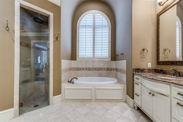 bathroom featuring vanity, a shower stall, and a bath