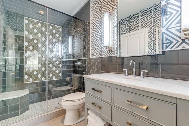 full bathroom with toilet, a stall shower, tile walls, decorative backsplash, and vanity