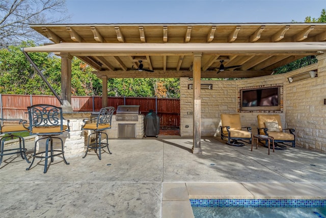 view of patio featuring area for grilling, a ceiling fan, and fence