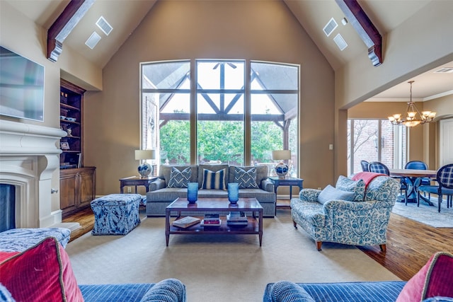 living room with visible vents, high vaulted ceiling, built in features, a fireplace, and a chandelier