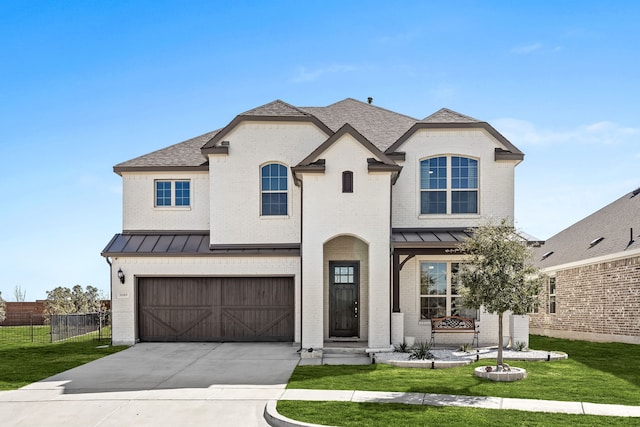 french provincial home featuring a standing seam roof, a front lawn, fence, and brick siding