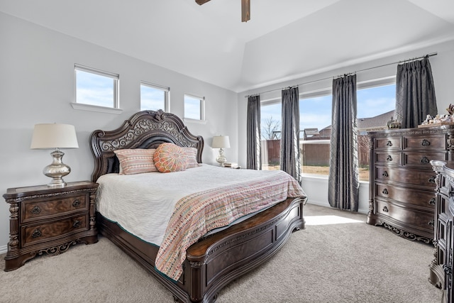 bedroom with a ceiling fan, vaulted ceiling, and light colored carpet