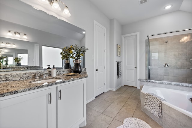 bathroom with visible vents, a garden tub, a tile shower, tile patterned flooring, and vanity