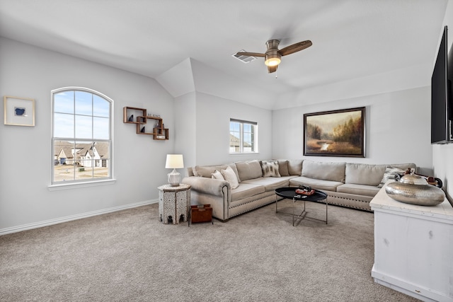 carpeted living room featuring ceiling fan and baseboards