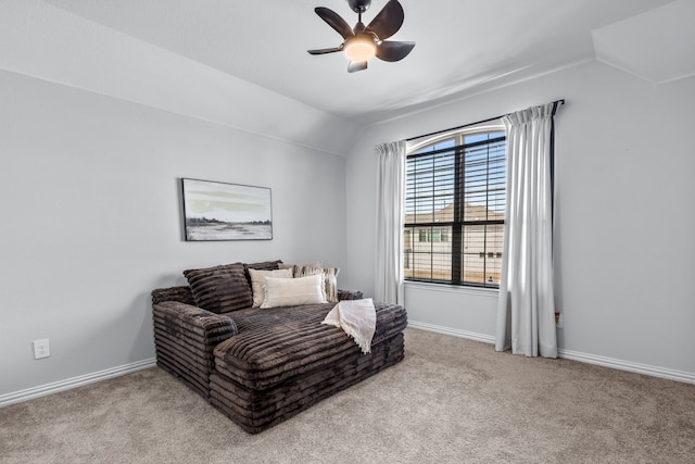 living area with baseboards, a ceiling fan, carpet flooring, and vaulted ceiling