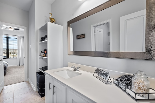 bathroom with tile patterned floors, vanity, and baseboards