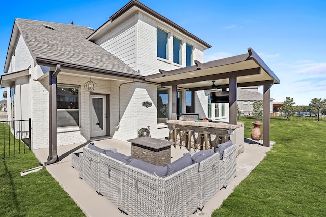 rear view of property with brick siding, outdoor dry bar, an outdoor hangout area, a yard, and a patio