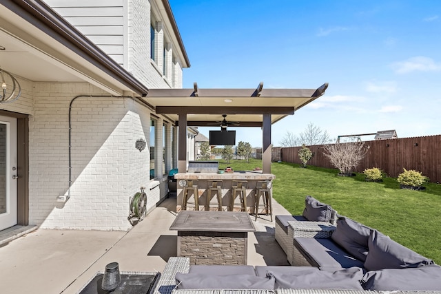 view of patio / terrace featuring outdoor dry bar, ceiling fan, an outdoor hangout area, and a fenced backyard