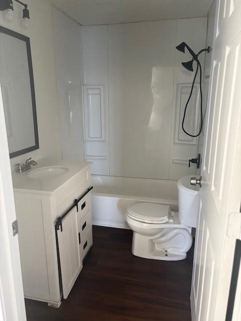 bathroom with vanity, shower / bathing tub combination, toilet, and wood finished floors