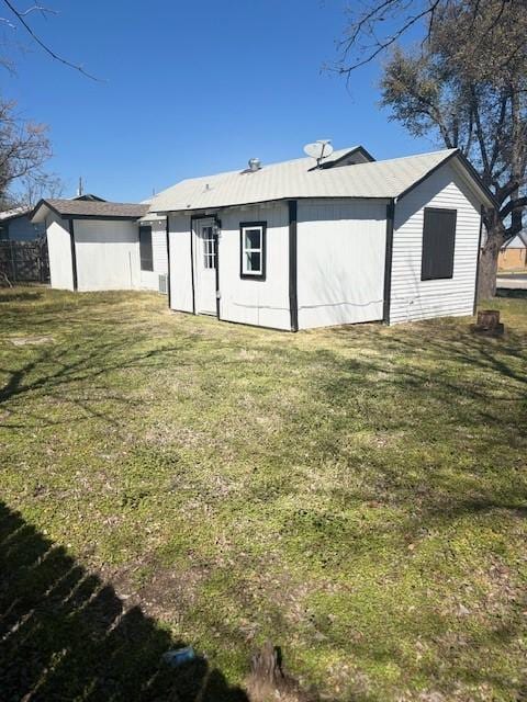 rear view of house featuring a lawn