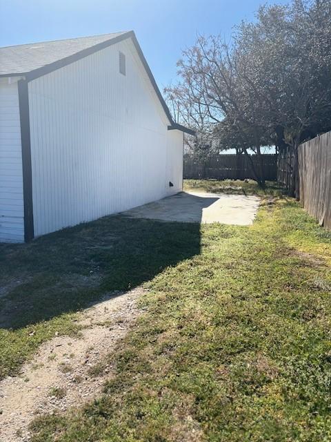 view of yard featuring a patio and fence