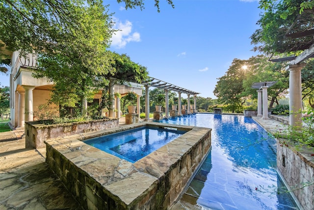 outdoor pool featuring a patio, an in ground hot tub, and a pergola