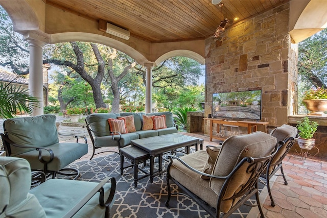 view of patio / terrace with an outdoor living space with a fireplace