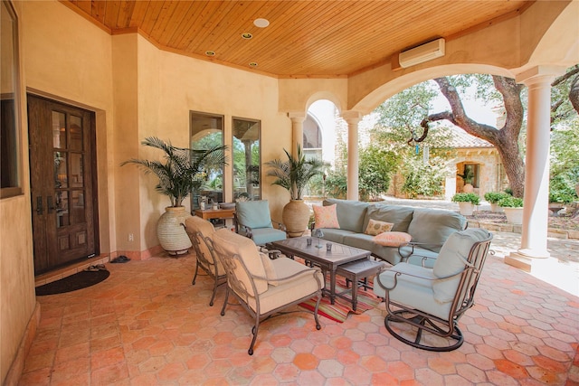 view of patio featuring an outdoor hangout area and an AC wall unit