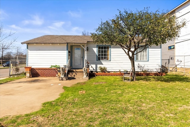 view of front of home with a front lawn and fence