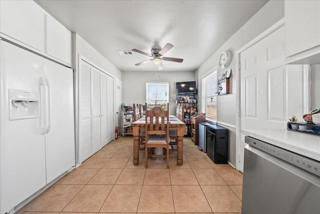 dining room with light tile patterned floors, a ceiling fan, and visible vents