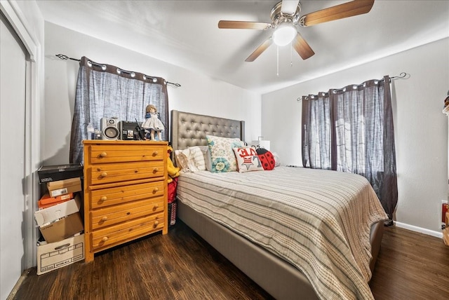 bedroom featuring baseboards, wood finished floors, and a ceiling fan