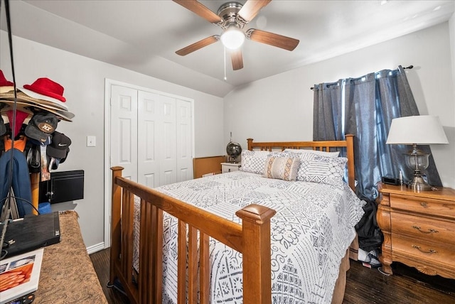 bedroom with baseboards, lofted ceiling, wood finished floors, a closet, and a ceiling fan