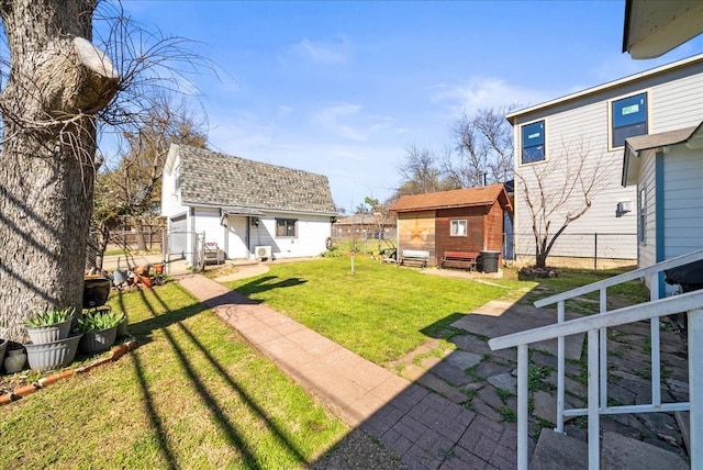 view of yard featuring an outbuilding and fence