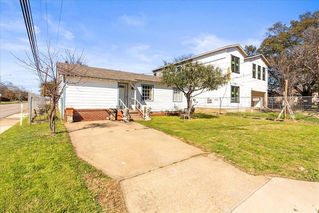 view of front of property with entry steps, a front yard, and fence