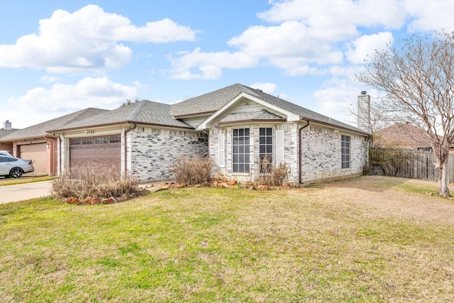 ranch-style home featuring fence, a front yard, an attached garage, brick siding, and a chimney