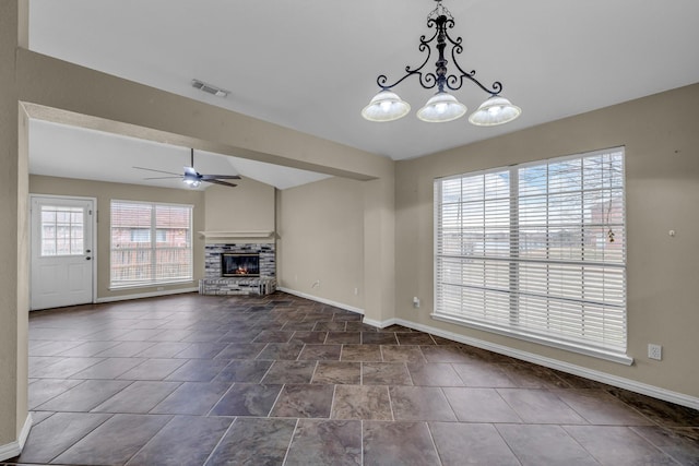 unfurnished living room featuring visible vents, baseboards, lofted ceiling, a glass covered fireplace, and ceiling fan with notable chandelier