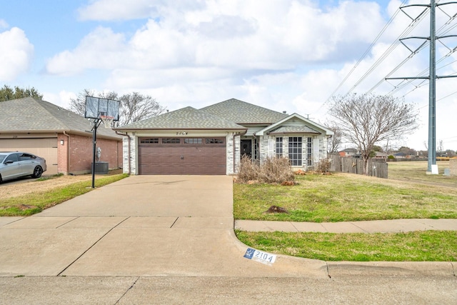 single story home with fence, driveway, a front lawn, a garage, and central air condition unit