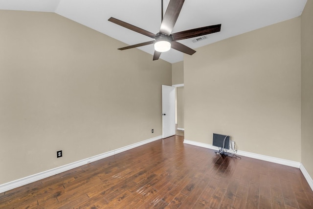 empty room featuring visible vents, baseboards, lofted ceiling, wood finished floors, and a ceiling fan