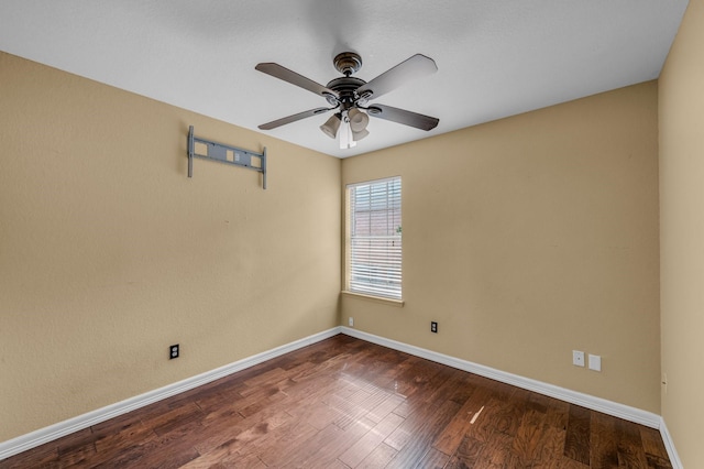 unfurnished room with ceiling fan, baseboards, and dark wood-style flooring