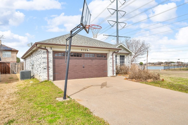 garage with fence and central AC