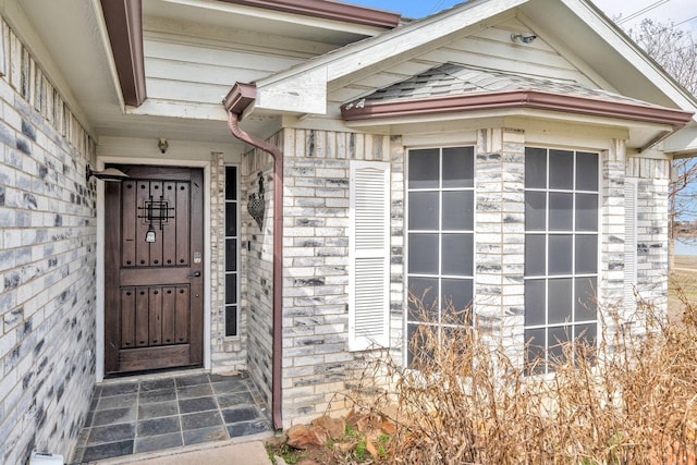 property entrance featuring stone siding