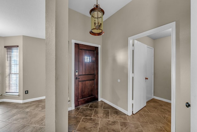 foyer entrance featuring baseboards