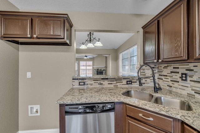 kitchen with a ceiling fan, a peninsula, a sink, dishwasher, and tasteful backsplash