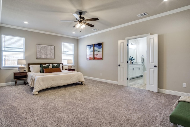 bedroom featuring visible vents, baseboards, light colored carpet, ornamental molding, and ensuite bathroom