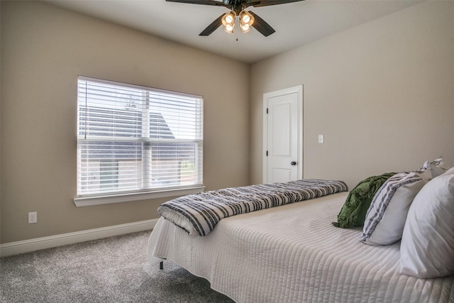 carpeted bedroom with baseboards and a ceiling fan