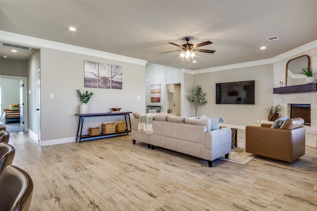 living area with light wood-type flooring, a fireplace, visible vents, and ceiling fan