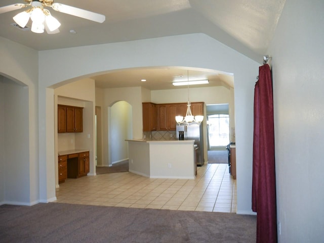 kitchen featuring light carpet, open floor plan, ceiling fan, and lofted ceiling