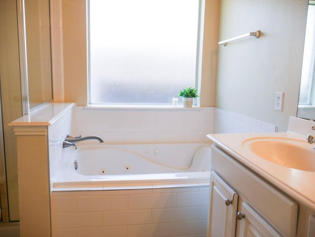 full bathroom featuring an enclosed shower, a tub with jets, and vanity