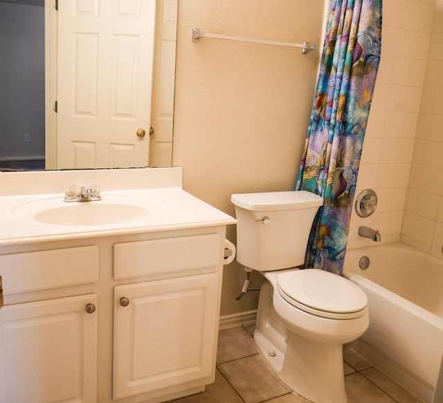 bathroom featuring toilet, shower / bath combo, tile patterned flooring, baseboards, and vanity