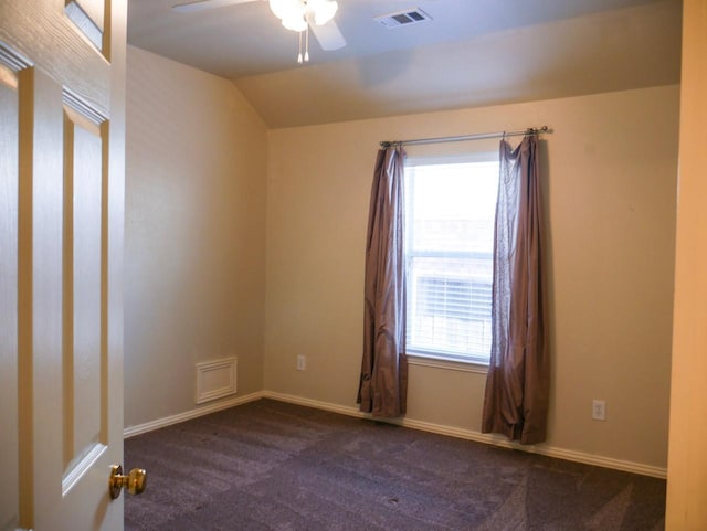unfurnished room featuring a ceiling fan, baseboards, visible vents, lofted ceiling, and carpet flooring