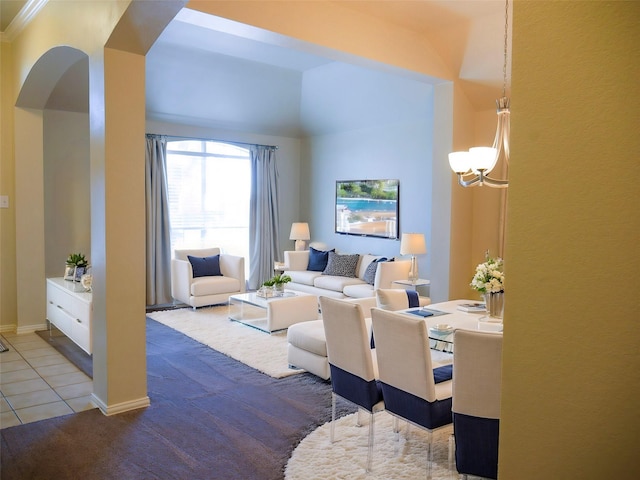 tiled living area featuring baseboards, arched walkways, and an inviting chandelier