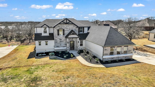 view of front of property featuring stone siding and a front lawn