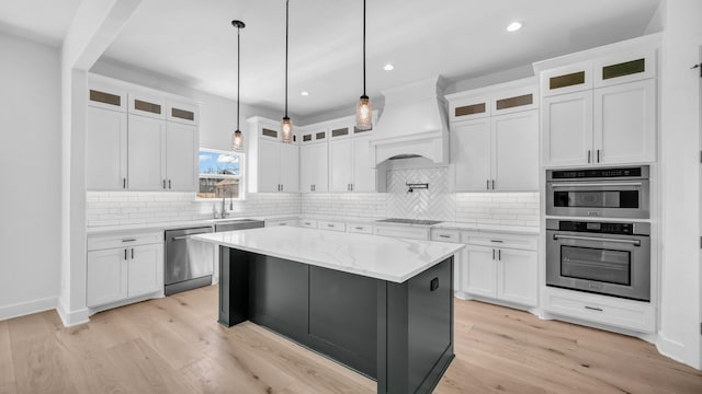 kitchen featuring light wood-type flooring, premium range hood, backsplash, and stainless steel appliances