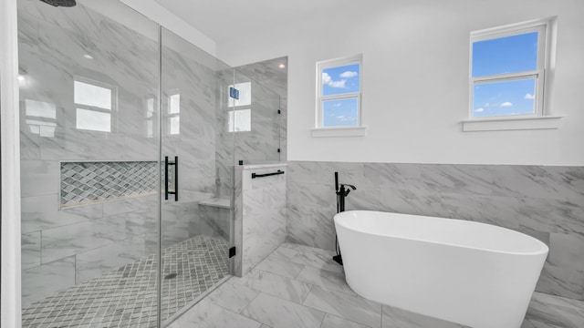 bathroom with a marble finish shower, a wainscoted wall, marble finish floor, and a freestanding bath