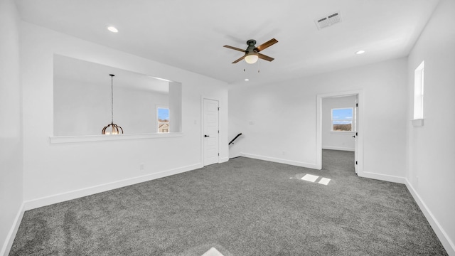 empty room with recessed lighting, visible vents, dark carpet, and baseboards