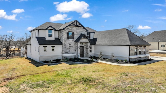 french country style house with stone siding, stucco siding, and a front yard