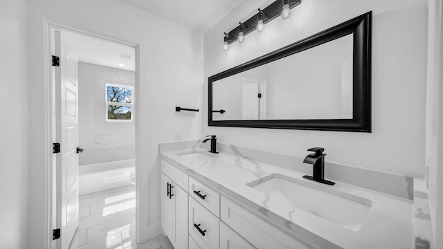 bathroom with double vanity, walk in shower, marble finish floor, and a sink